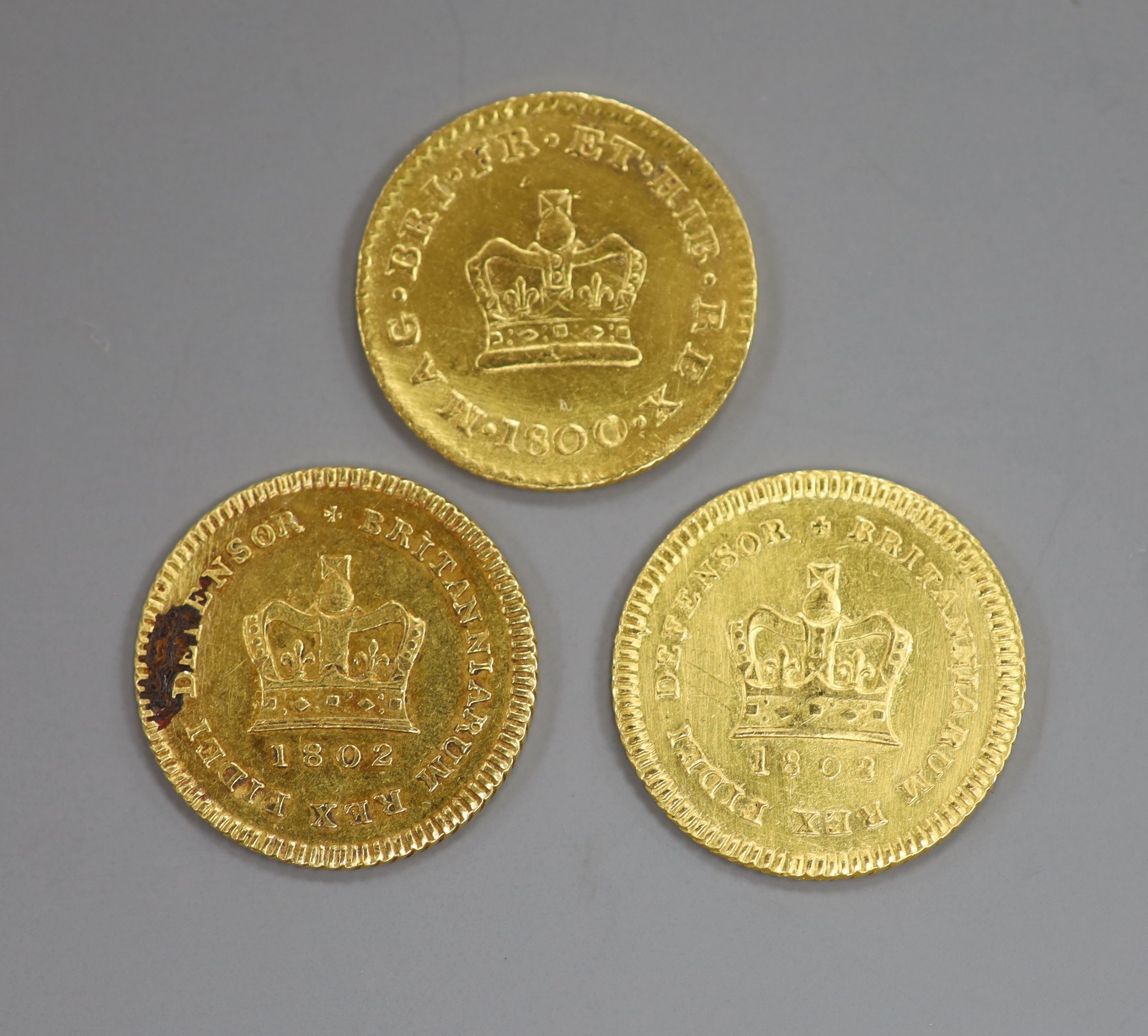 Three George III gold one third guineas, 1800 & 1802(2).